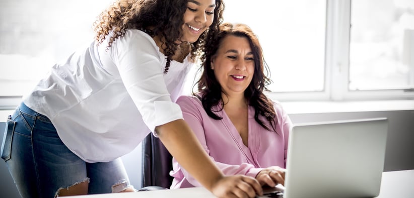 Daughter helping mom on her computer